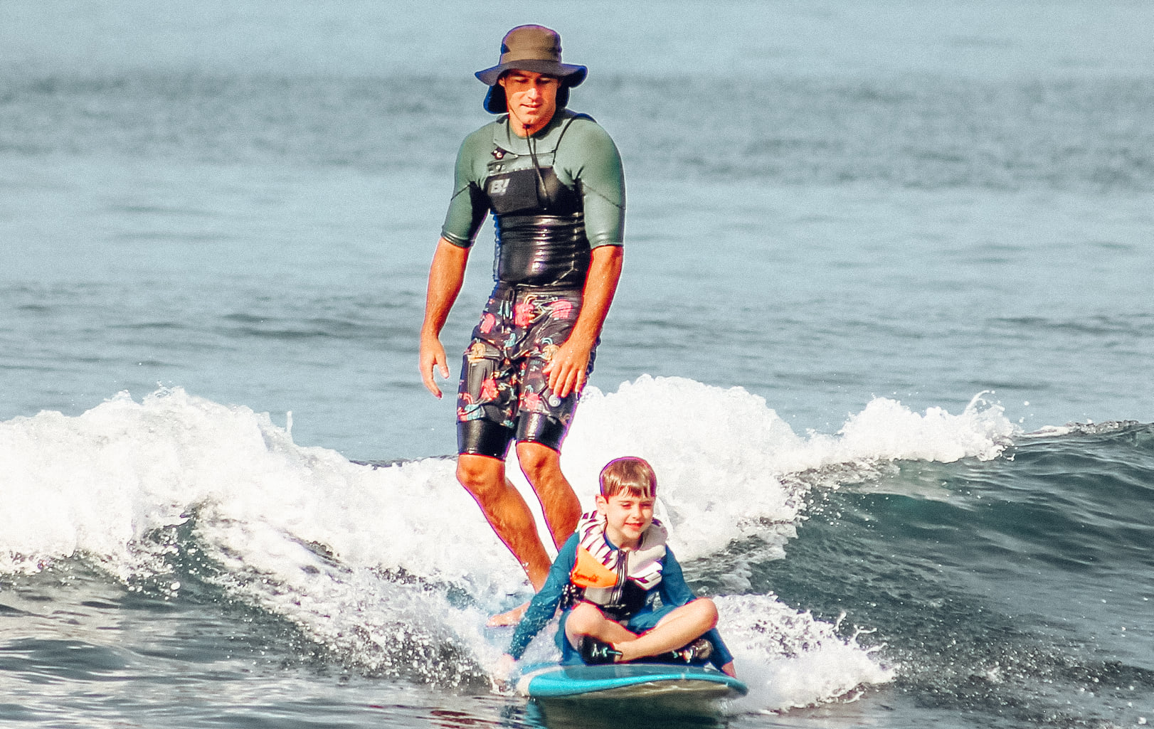 maui surf instructor teaching young boy how to surf | maui life surf adventures